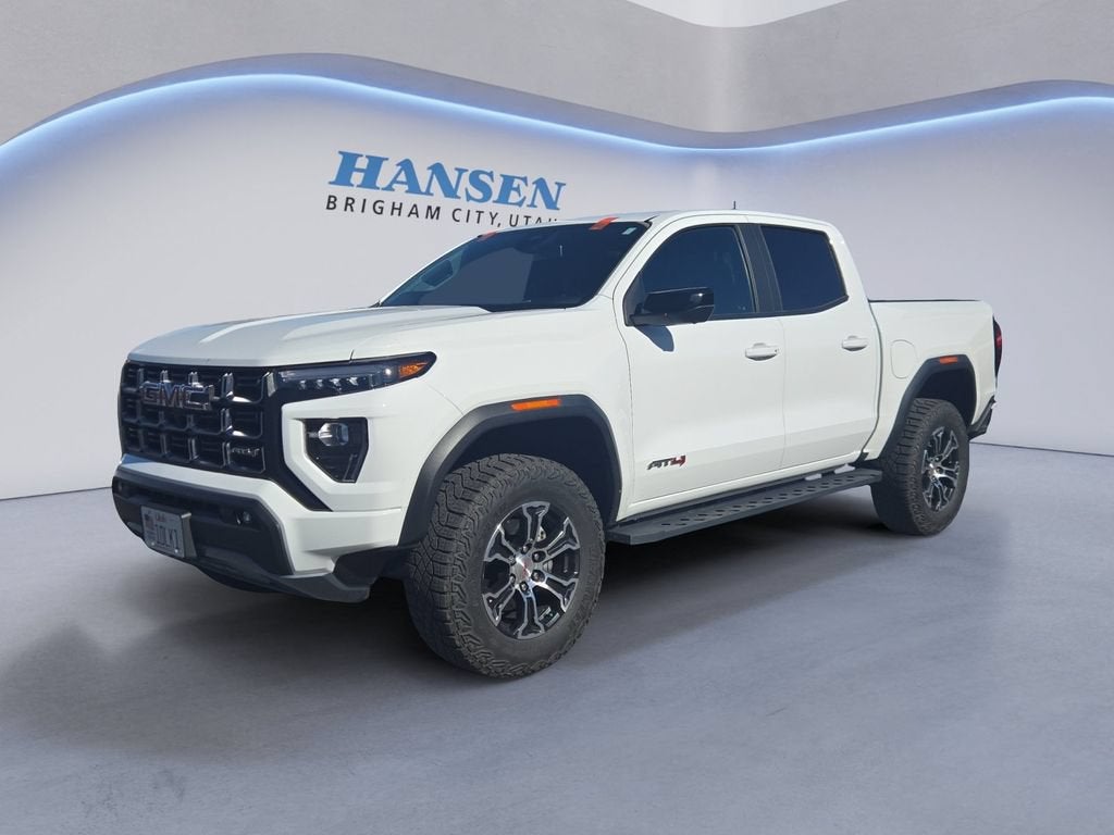 2024 GMC Canyon AT4 in Summit White — front three-quarter view